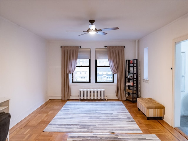 spare room featuring radiator heating unit, baseboards, and ceiling fan