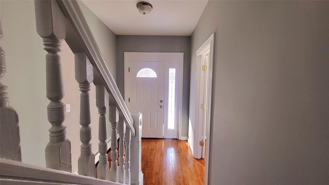 entrance foyer featuring wood finished floors and stairs