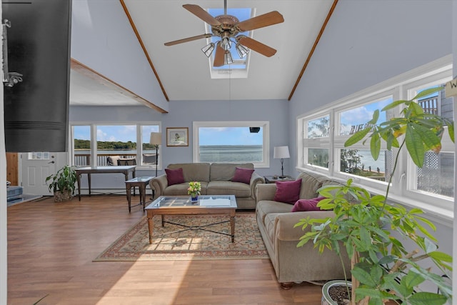 sunroom with ceiling fan, vaulted ceiling, and a baseboard radiator