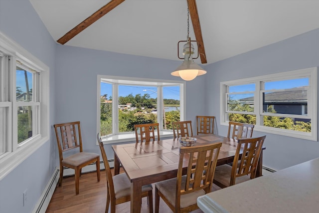 dining room with vaulted ceiling with beams, baseboard heating, plenty of natural light, and wood finished floors