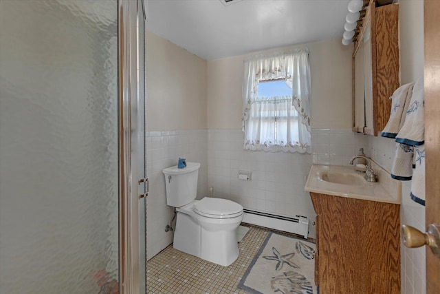 full bathroom featuring tile walls, toilet, baseboard heating, vanity, and tile patterned flooring