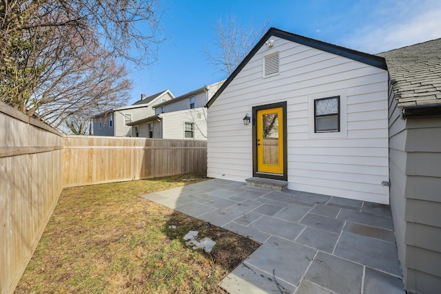 back of house with a patio area, a fenced backyard, and a yard