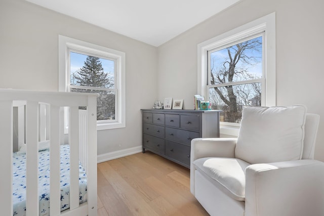 bedroom featuring light wood-style flooring and baseboards