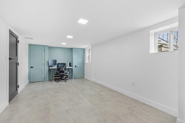 unfurnished office featuring baseboards