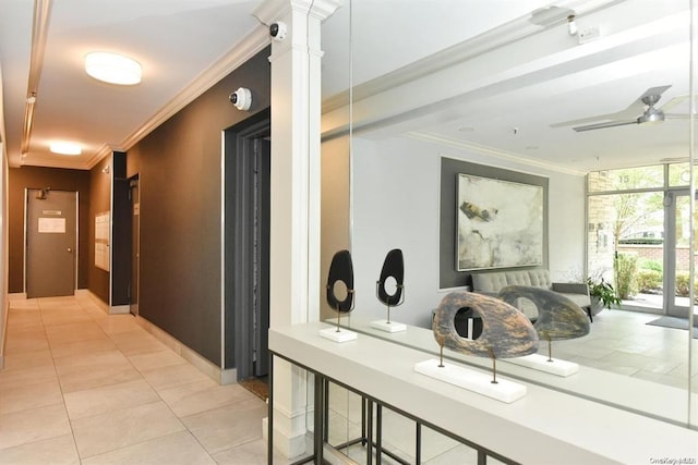 corridor featuring light tile patterned floors, decorative columns, and ornamental molding