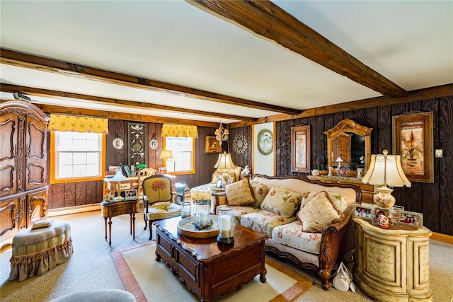 living area featuring wood walls, baseboard heating, beam ceiling, and carpet flooring