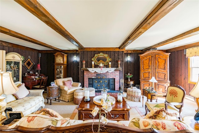 carpeted living room featuring a brick fireplace, beam ceiling, and wood walls