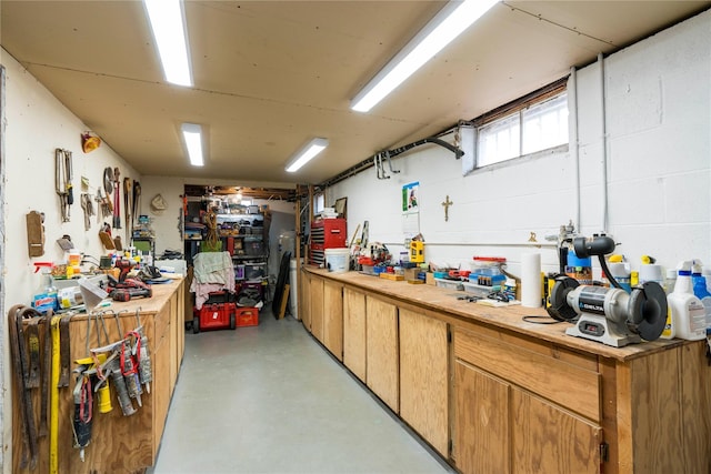 interior space featuring concrete block wall and a workshop area