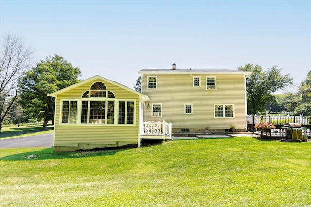 back of house with a yard and fence