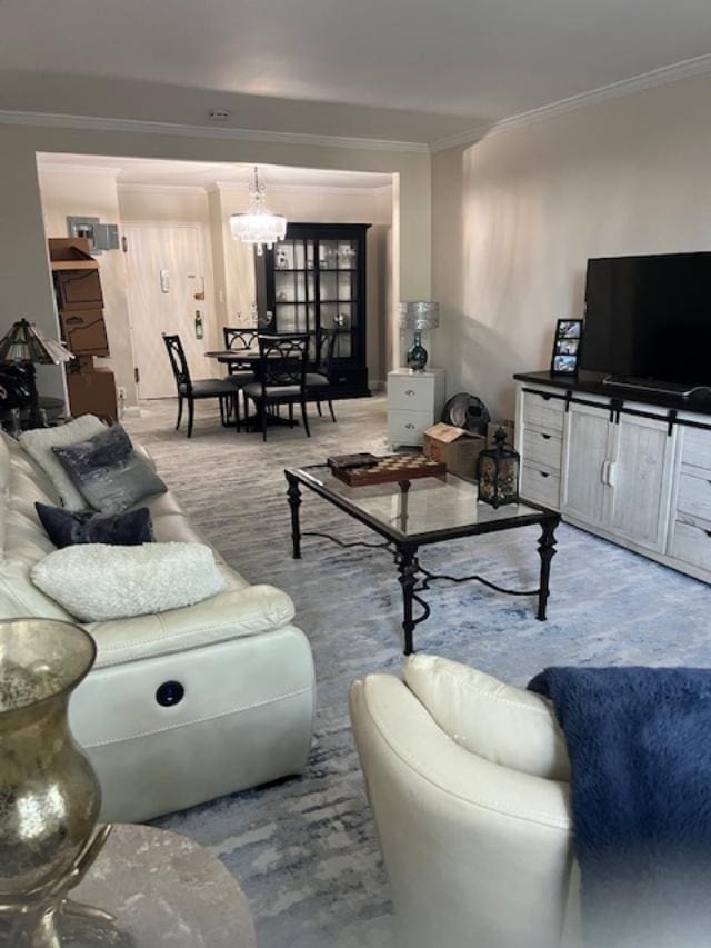 living room featuring a chandelier and crown molding