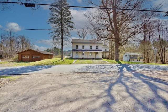 5 Plank Rd, Mongaup Valley, NY 12762 - view of front of property with a porch, an outbuilding, and a front yard