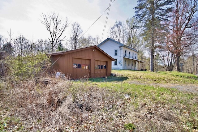 5 Plank Rd, Mongaup Valley, NY 12762 - view of side of home with a garage, board and batten siding, and a lawn