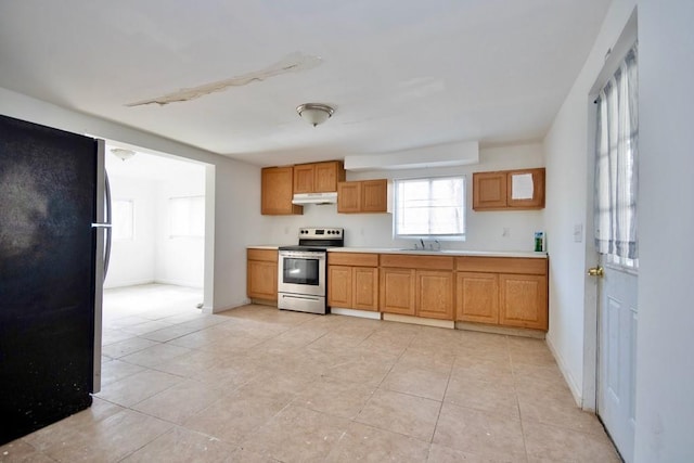 5 Plank Rd, Mongaup Valley, NY 12762 - kitchen with a sink, under cabinet range hood, light tile patterned floors, light countertops, and appliances with stainless steel finishes