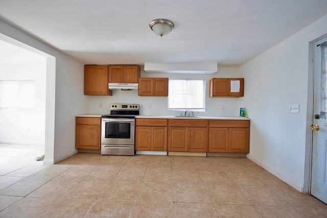 5 Plank Rd, Mongaup Valley, NY 12762 - kitchen featuring under cabinet range hood, light countertops, brown cabinets, a sink, and stainless steel range with electric stovetop
