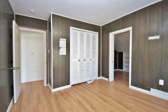 5 Plank Rd, Mongaup Valley, NY 12762 - unfurnished bedroom with a closet, ornamental molding, light wood finished floors, baseboards, and wooden walls