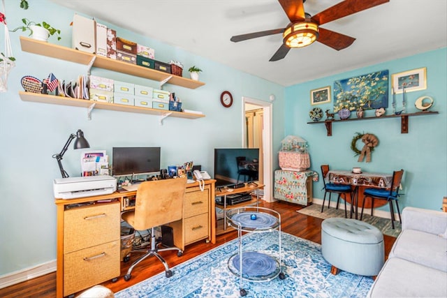 office featuring wood finished floors, a ceiling fan, and baseboards