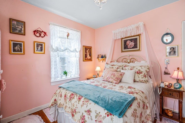 bedroom with wood finished floors and baseboards