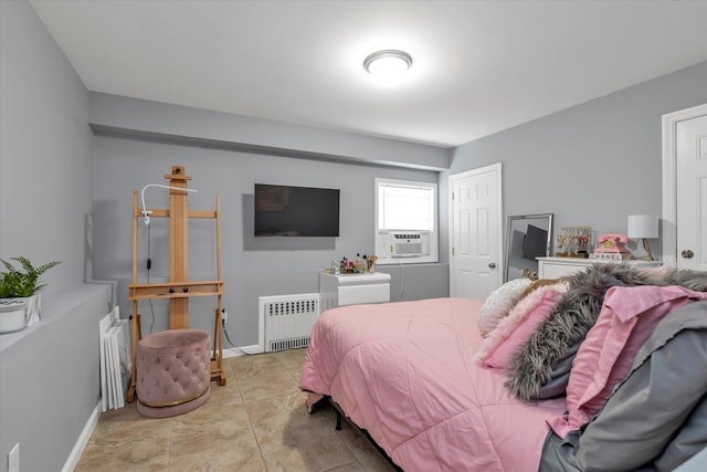 bedroom featuring cooling unit, baseboards, and radiator