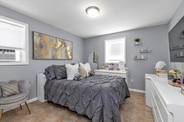 bedroom with cooling unit, light tile patterned flooring, and baseboards