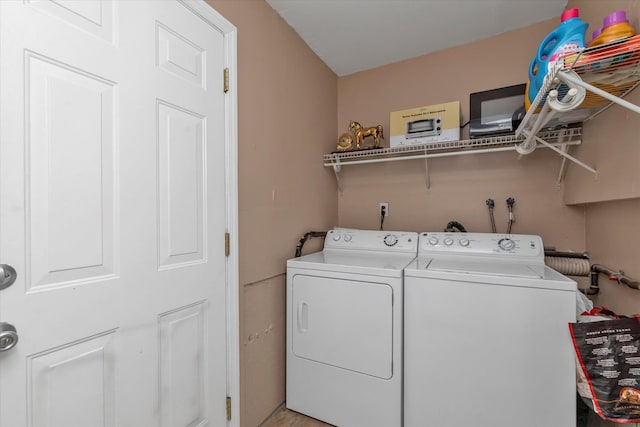 washroom with washing machine and dryer and laundry area