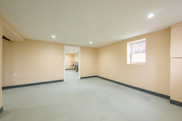 empty room featuring finished concrete flooring, visible vents, baseboards, and recessed lighting