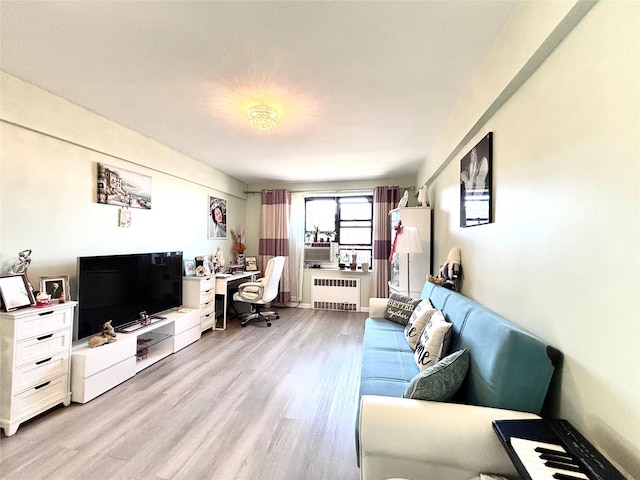 living area with light wood-type flooring and radiator heating unit