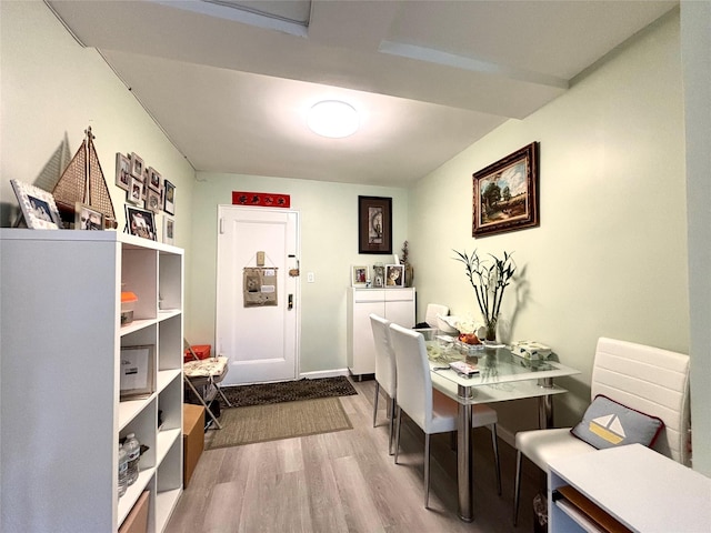 dining space featuring dark wood-style floors and baseboards