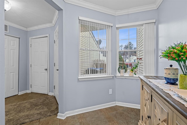 interior space with baseboards, visible vents, and ornamental molding