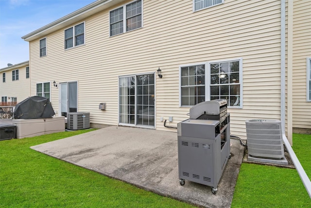 back of house with a yard, a patio, and central AC unit