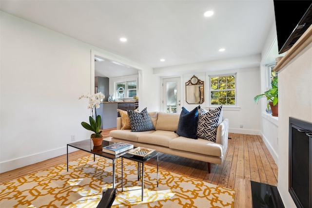 living room with hardwood / wood-style flooring, baseboards, and recessed lighting