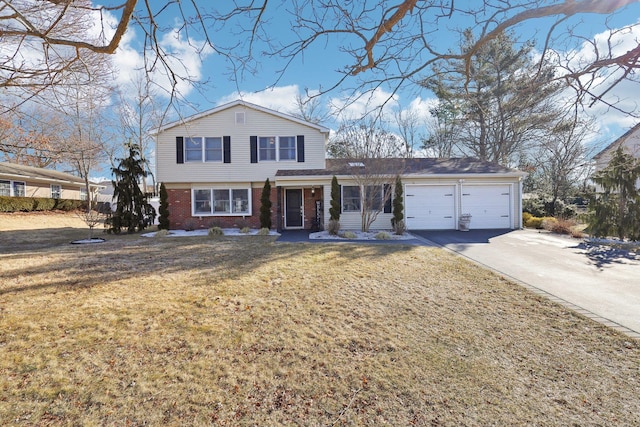 traditional-style home featuring an attached garage, a front yard, concrete driveway, and brick siding