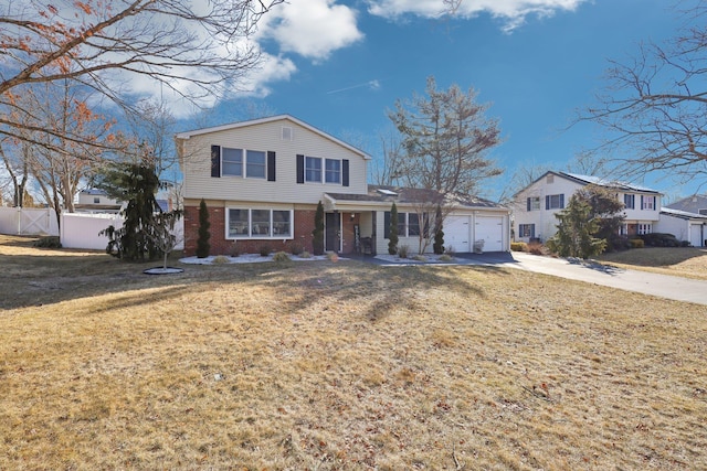 traditional home featuring brick siding, concrete driveway, an attached garage, fence, and a front yard