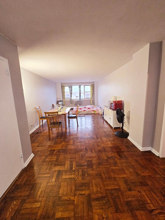 unfurnished dining area with a textured ceiling and baseboards