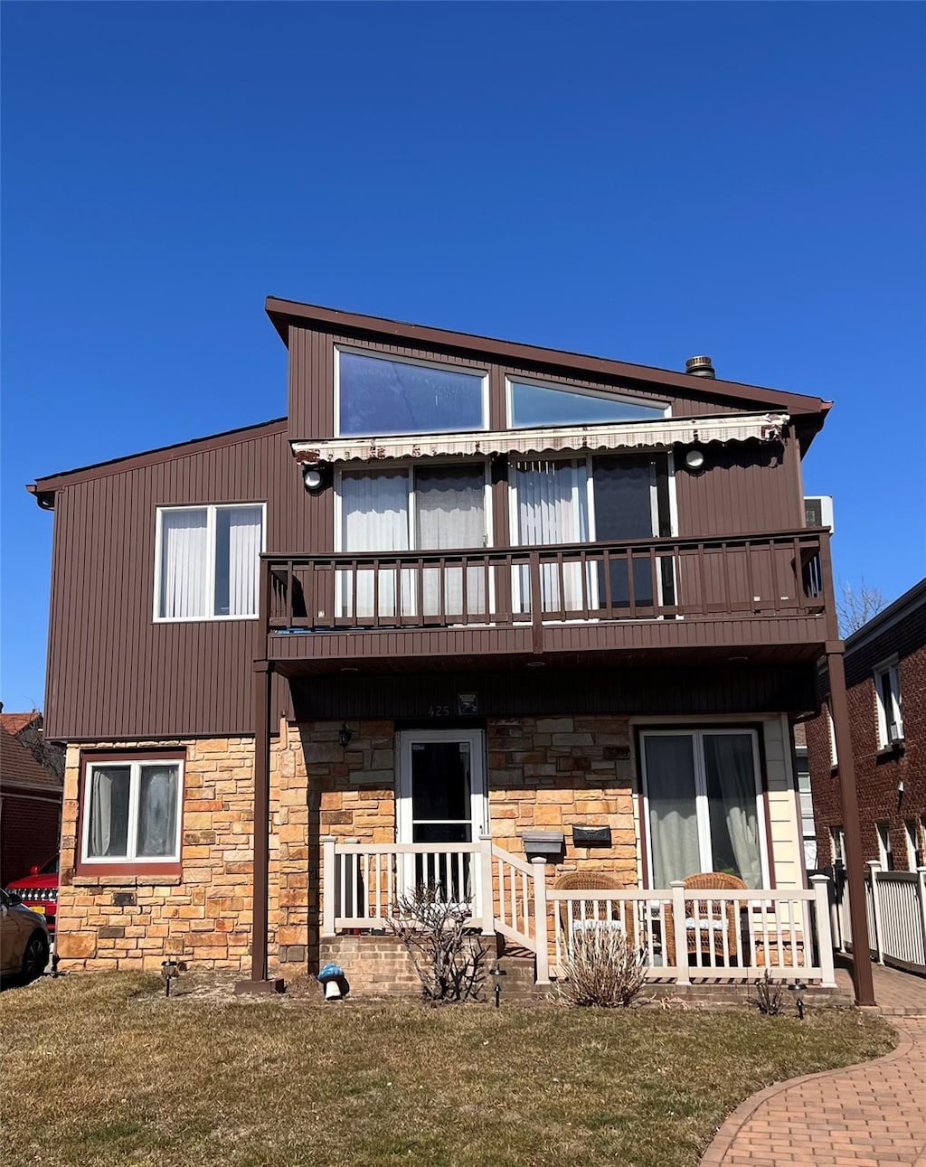 rear view of house with covered porch and a balcony