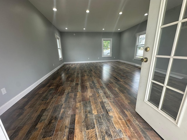 unfurnished room featuring baseboards, hardwood / wood-style floors, and recessed lighting