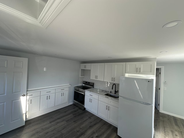 kitchen featuring stainless steel range with electric stovetop, freestanding refrigerator, white cabinets, and a sink