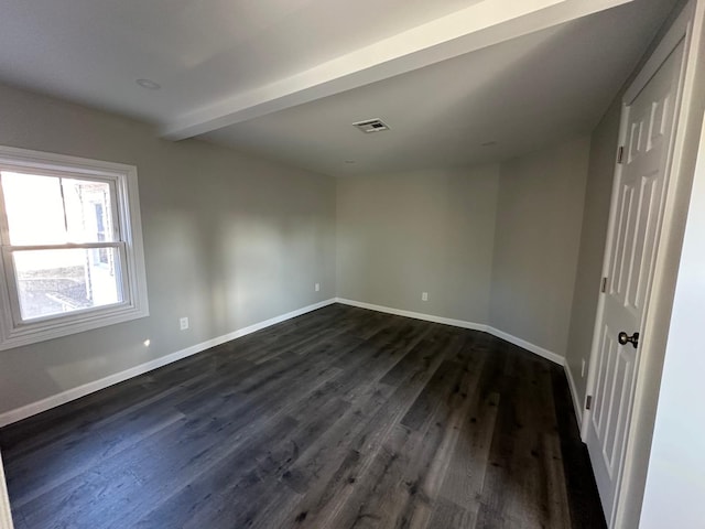 empty room featuring dark wood-style floors and baseboards