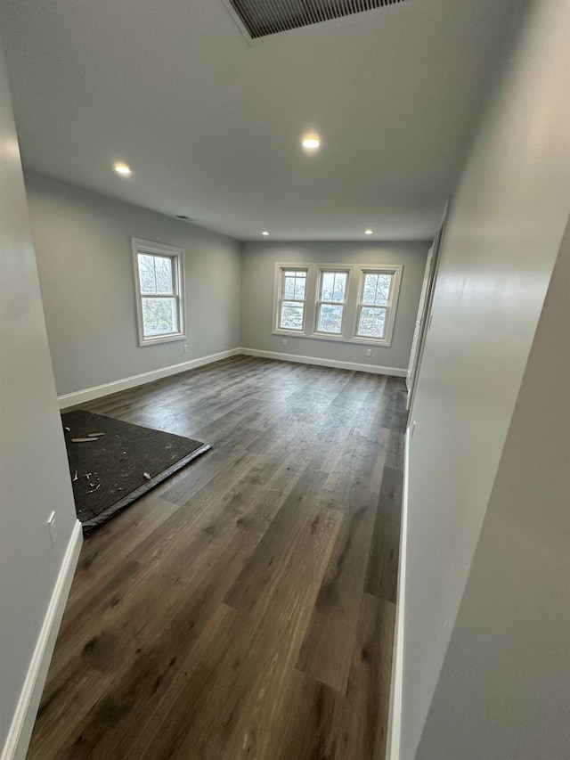 empty room featuring recessed lighting, visible vents, baseboards, and wood finished floors