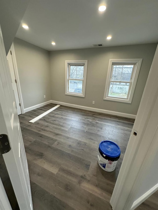 unfurnished bedroom with dark wood-type flooring, recessed lighting, and visible vents