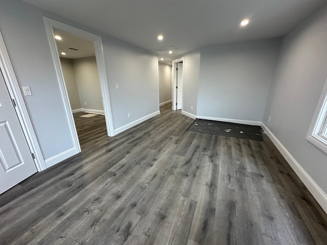 unfurnished room with baseboards, wood finished floors, and recessed lighting