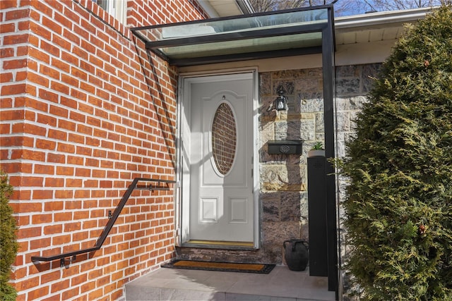 property entrance featuring brick siding