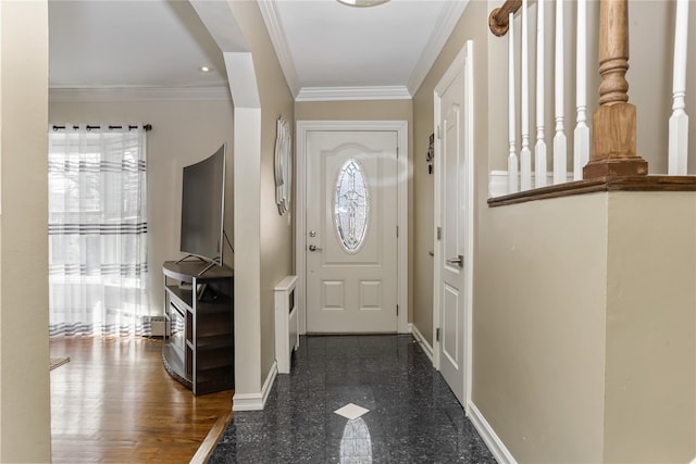 foyer with crown molding, granite finish floor, and baseboards