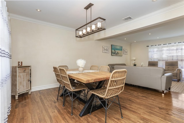 dining area featuring baseboards, visible vents, wood finished floors, crown molding, and recessed lighting