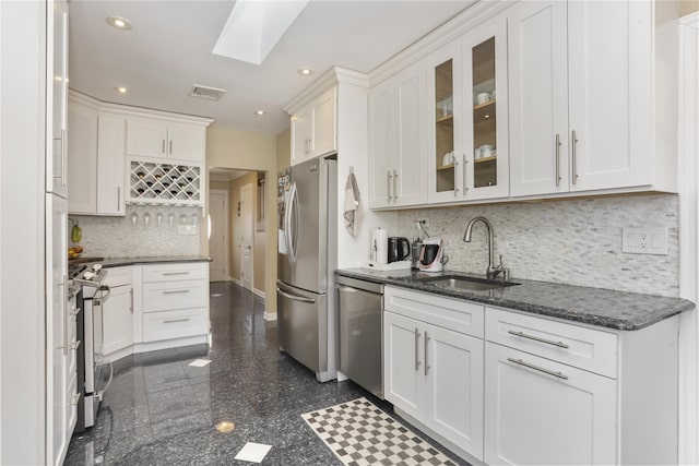 kitchen with visible vents, white cabinets, appliances with stainless steel finishes, granite finish floor, and a sink