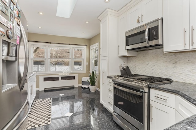 kitchen with baseboards, stainless steel appliances, granite finish floor, and recessed lighting