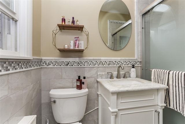 bathroom with toilet, wainscoting, radiator, and vanity