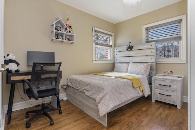 bedroom featuring wood finished floors and baseboards