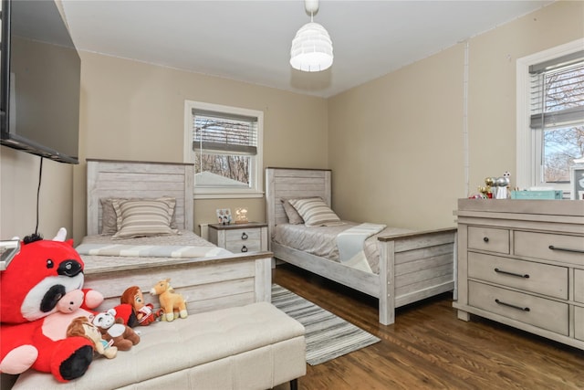 bedroom with dark wood-style flooring