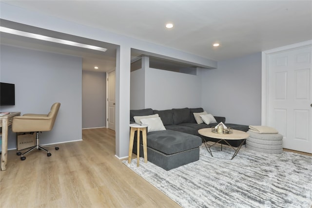 living room with light wood-type flooring, baseboards, and recessed lighting