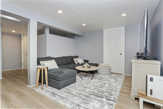 living area featuring light wood-type flooring and recessed lighting